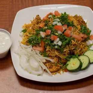 a plate of food with cucumbers and onions