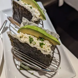 BLUE CRAB NORI TACOS Blue crab meat, seasoned rice, avocado, lemon zest, mayonnaise, &amp; chives in crispy nori shells. $18