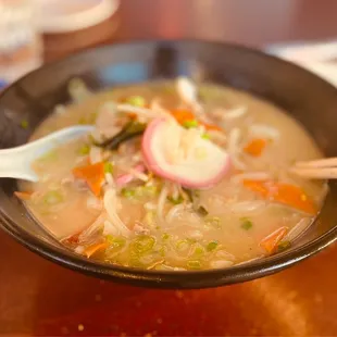 a bowl of soup and chopsticks
