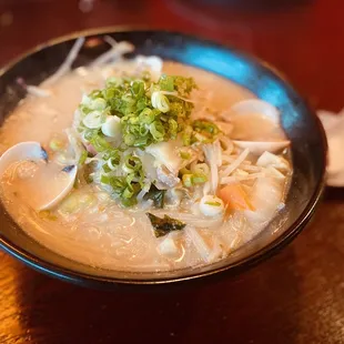 a bowl of soup on a wooden table