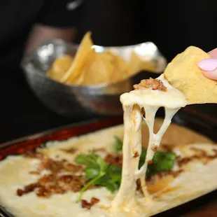 The queso came to the table bubbling hot in a skillet. The cheese was thick making for epic cheese pulls.