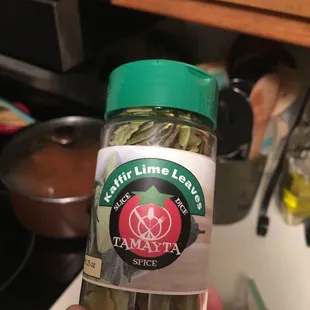 a hand holding a jar of tamayta