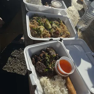 Adobo combo plate with lumpia, pancit, and BBQ pork