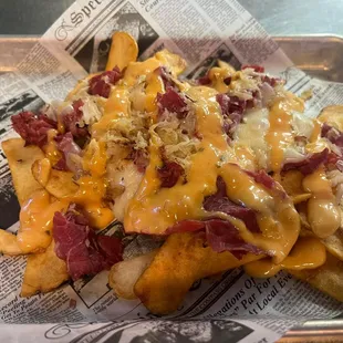 a tray of french fries with cheese and bacon