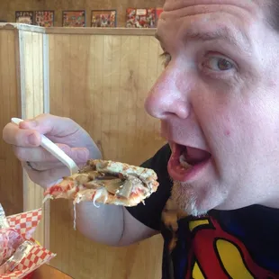 My dad chowing down on pizza.