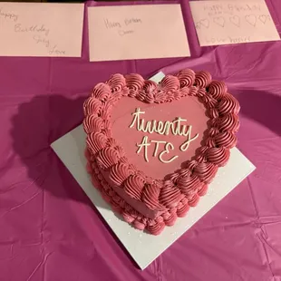 Heart-shaped chocolate cake with hot pink (color created by the team) frosting.