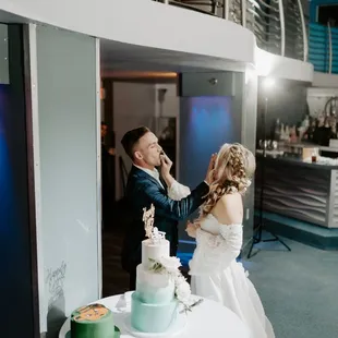 a bride and groom feeding each other a piece of cake