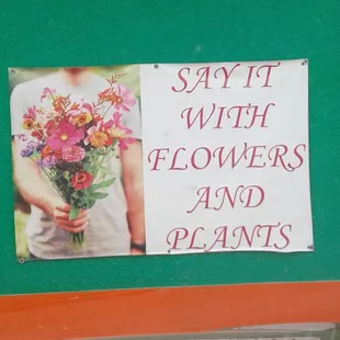 a sign with flowers and plants