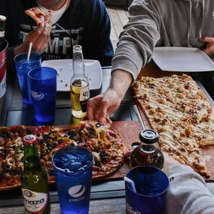 Pictured: Gasparilla pizza, bacon chicken ranch pizza, pepperoni pizza, $20 bucket of beer, Love Potion Sangria