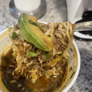Ramen noodles, shredded beef, cilantro and avocado.