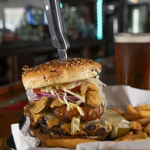 a burger with a knife sticking out of it