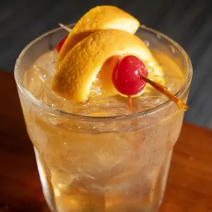 a cocktail with a cherry garnish