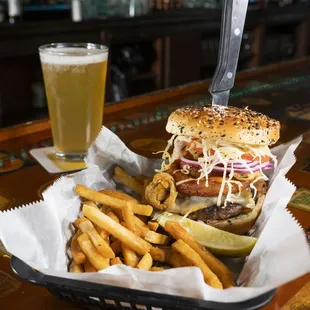 a basket of food and a glass of beer