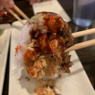 a close up of a plate of food with chopsticks