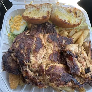 Boneless chicken dinner with half fries and half zucchini.