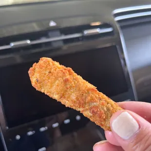 a hand holding a piece of food