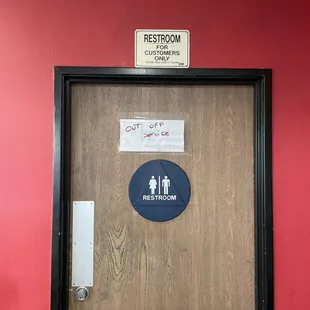 a restroom door with stickers on it