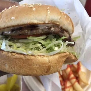 a hand holding a hamburger