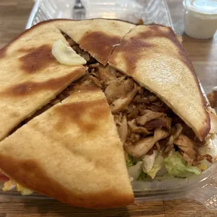 Warm pita bread on top of chicken salad