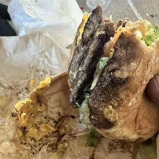 The dark spots is dirty oil and soot from the grill on the meat and bread, both burgers were the same and no flavor