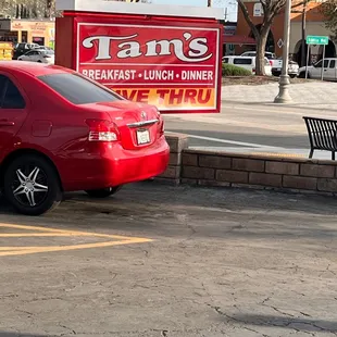 a red car parked in a parking lot