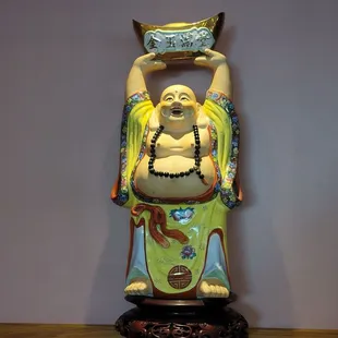 a statue of a man holding a bowl