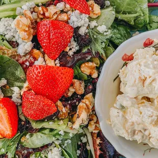 a salad with strawberries and walnuts