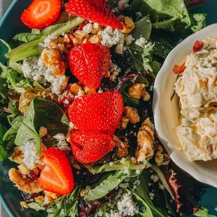 a salad with strawberries and walnuts