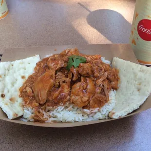 African-spiced Chicken Curry Served over Jasmine Rice with Pita and a Coca-Cola®