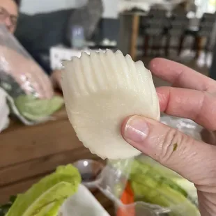 a person holding a piece of food