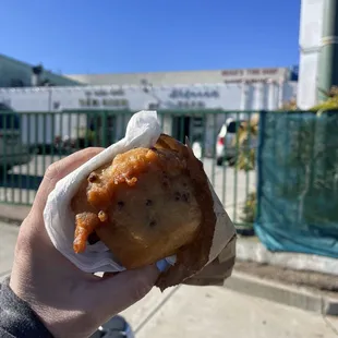 a person holding a piece of food