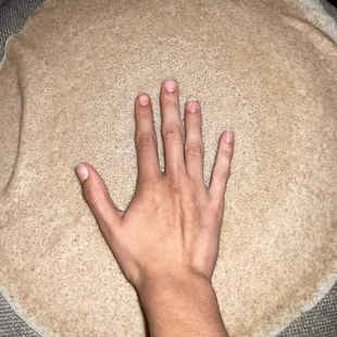 Hand relative to injera...it's huge