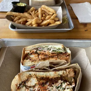 Spicy Chicken Katsu Sandwich in foreground, regular Chicken Katsu Sandwich with fries and curry sauce in background