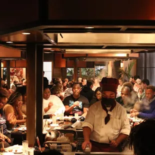 a large group of people eating at a restaurant