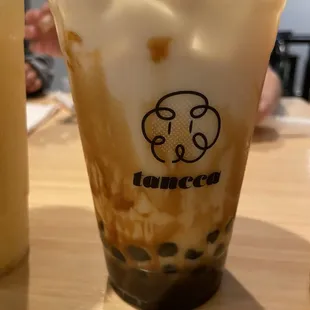 a cup of iced coffee on a table