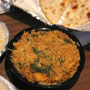 Fish Biryani ($16.95) Salmon marinated in yogurt, tomatoes, herbs and spices, cooked with spiced flavored Basmati rice and saffron.