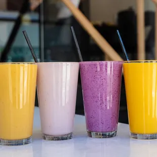 Try out our refreshing Lassi&apos;s in four flavors. From Left to Right: Strawberry Mango, Strawberry, Blueberry, Mango.