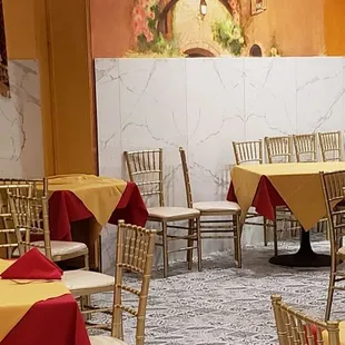 tables and chairs with red tablecloths