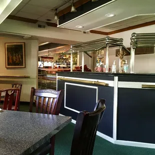 a dining area with tables and chairs