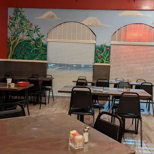 a dining area with tables and chairs