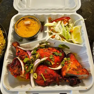 chicken and rice in a styrofoam container