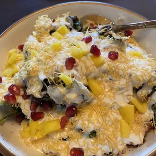 Palak Chat App: crispy spinach, tangy yogurt sauce, garnished with pineapple and fresh pomegranate seeds-exquisite!