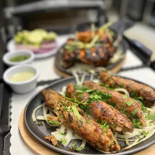 two plates of tandoori on a table