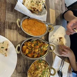 Delicious chicken biryani, tikka masala, naan bread, and aloo gobhi.