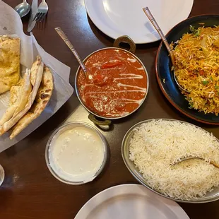 Butter chicken, garlic naan, chicken biryani and ratika(yogurt)