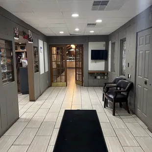 a long hallway with a black carpet