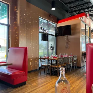 a red booth with a bottle of wine on the table