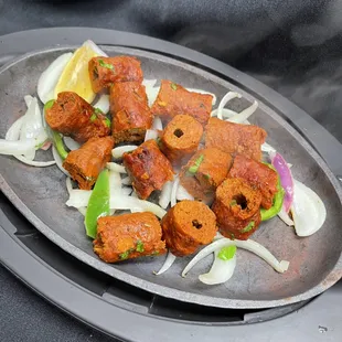 Seekh kabab is a minced lamb mixed with herbs and spices cooked in a clay oven ( Tandoor)