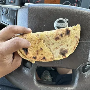 a person holding a piece of food