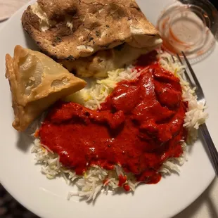 Naan, butter chicken, samosas and rice